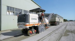 Milling off a concrete surface on organization premises.