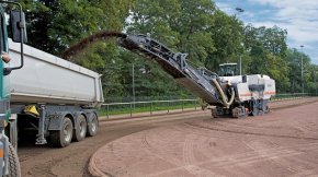 Milling off the area of a cinder baseball pitch.